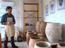 Юрій Пошивайло показує свою роботу - садову композицію з великих ваз, якою прикрасять територію музею-заповідника