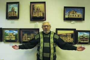 Художник Йосип Осташинський стоїть біля своїх картин із сірників. Їх виставляють у бібліотеці для дорослих на Мінському масиві столиці