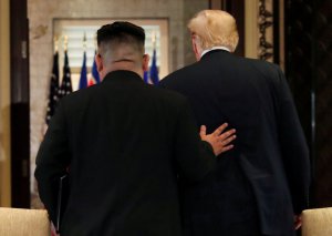 Лідер Північної Кореї Кім Чен Ин (на фото — ліворуч) і президент Сполу­чених Штатів Америки Дональд Трамп йдуть під час зустрічі в готелі ”Капела” на острові Сентоса в Сингапурі, 12 червня
