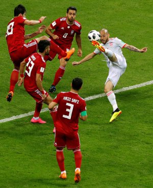 Гравець збірної Іспанії Давид Сілва (у білій формі) проти футболістів національної команди Ірану