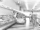 Супермаркеты "Publix" демонстрировали свои широкие проходы и молочный отдел самообслуживания, провозя покупателя своим магазином в крохотной машине, 1957