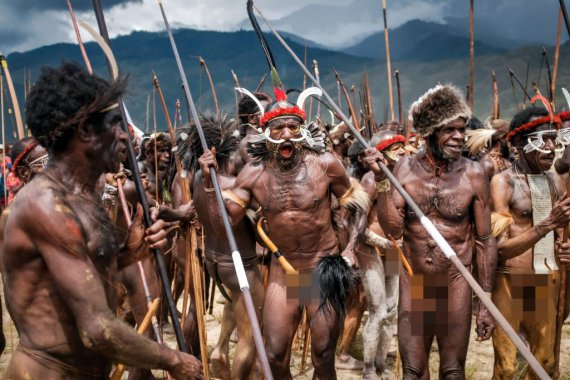 Мужчины из отдаленного племени Дани из индонезийской долины Балием в высокогорье Западного Папуа танцуют на фестивале