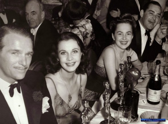 Фільм “Звіяні вітром” отримав загалом 13 номінацій “Оскар” і 8 нагород. Гості на церемонії нагородження. Зліва направо: Дуглас Фербенкс-молодший, Вів’єн Лі, Олівія де Гевілленд та Джок Вітні