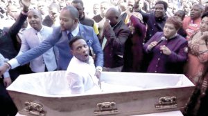 Чоловік, якого нібито воскресив пастор Альф Лукау, сидить у труні перед собором у Йоганнесбурзі, південноафриканській столиці