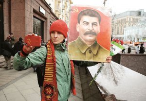 Жінка фотографується з портретом радянського диктатора Йосипа Сталіна під час мітингу на честь сторіччя Жовтневого перевороту в Москві, 7 листопада 2017 року