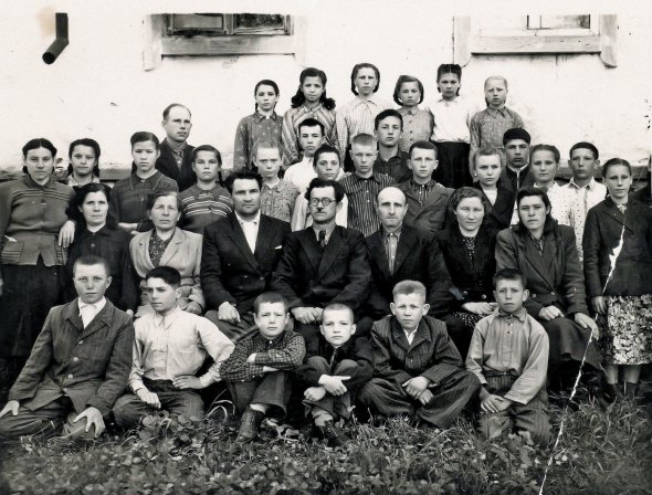 Вадим Скуратівський (у першому ряду четвертий ліворуч) з іншими учнями та вчителями сфотографувався на шкільному подвір'ї в селі Хибалівка Куликівського району на Чернігівщині. 1953 рік